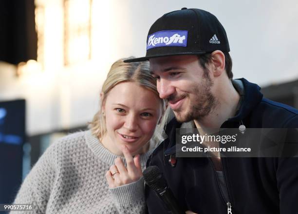 The ski racer Felix Neureuther and his wife, biathlete Miriam Neureuther sit together at a chat show during the official outfitting of the German...