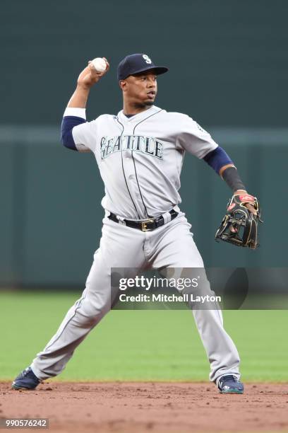 Jean Segura of the Seattle Mariners throws after fielding a ground ball during a baseball game against the Baltimore Orioles at Oriole Park at Camden...