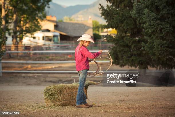 kleinen cowgirl üben, wenn die sonne untergeht abseilen - cowgirl hairstyles stock-fotos und bilder