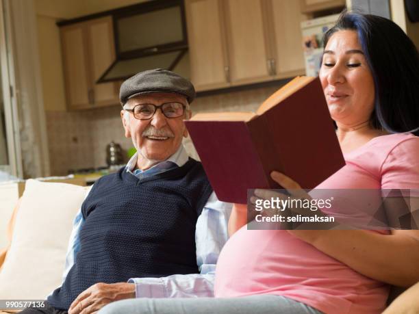 portrait of adult asisn woman takin care of senior man at home - takin stock pictures, royalty-free photos & images