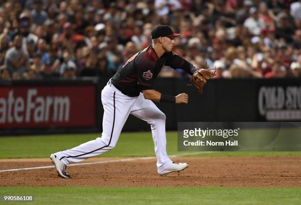 Jake Lamb of the Arizona Diamondbacks gets ready to catch a throw from center field against the San Francisco Giants at Chase Field on June 30, 2018...