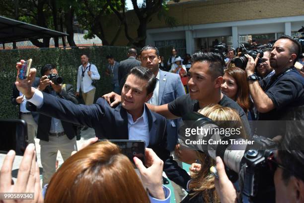 President of Mexico Enrique Pena Nieto poses for a selfie with followers after voting during the Mexico 2018 Presidential Election on July 1, 2018 in...