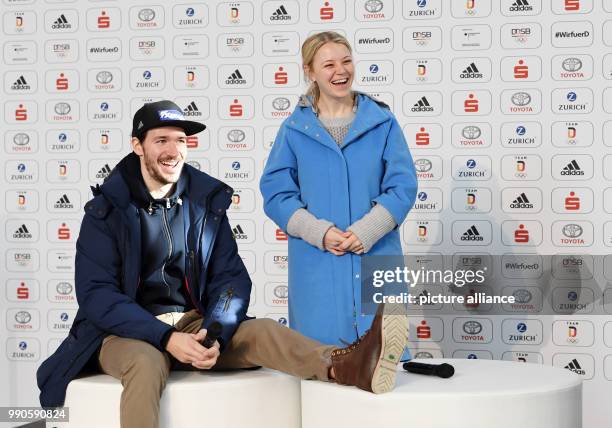 The ski racer Felix Neureuther and his wife, biathlete Miriam Neureuther sit together at a chat show during the official outfitting of the German...