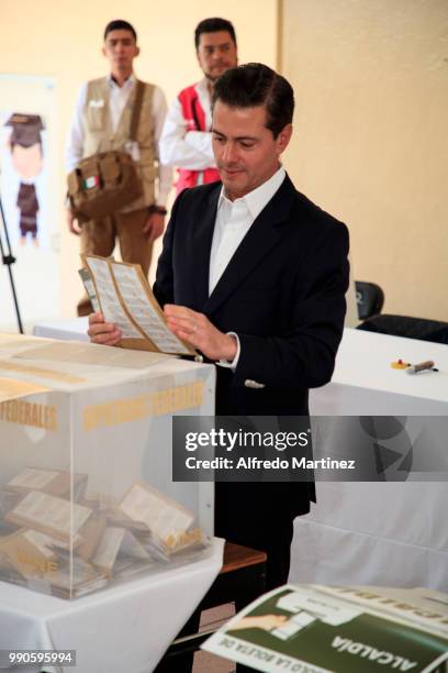 Mexican President Enrique Peña Nieto casts his vote in polling station at El Pipila School during the 2018 Presidential Elections in Mexico City on...