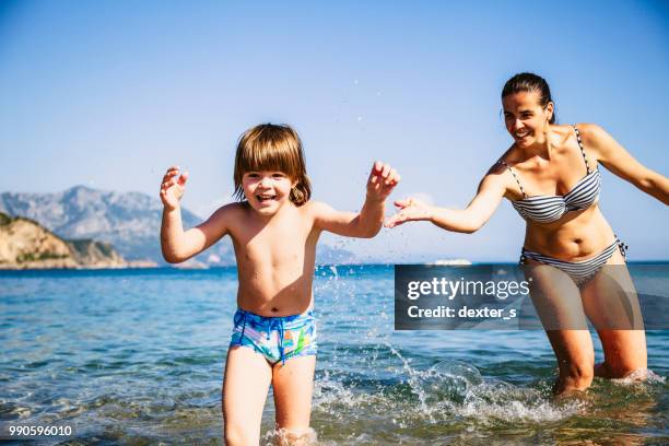 mother and son having fun in sea - dexters stock pictures, royalty-free photos & images