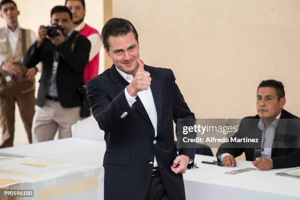 Mexican President Enrique Peña Nieto gives a thumb up after voting in polling station at Escuela Primaria El Pípila during the 2018 Presidential...