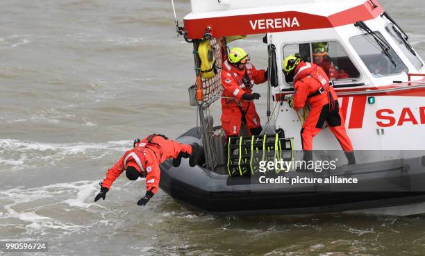 Actor Till Demtroeder, new embassador of the German Maritime Search and Rescue Service jumps out of the dinghy "Verena" wearing a survival suit in...