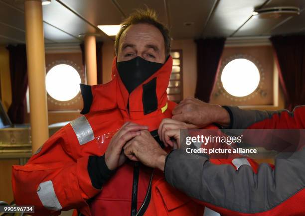 Actor Till Demtroeder, new embassador of the German Maritime Search and Rescue Service stands on deck of the Sea rescue boat "Hermann Marwede"...