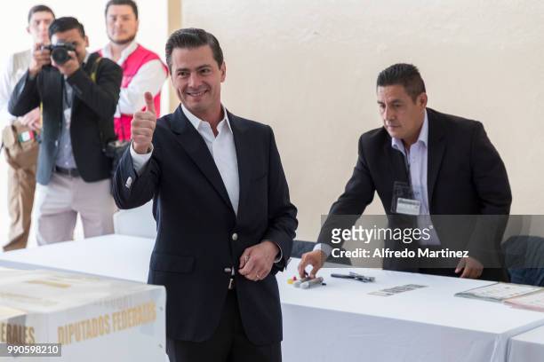 Mexican President Enrique Peña Nieto gives a thumb up after voting in polling station at Escuela Primaria El Pípila during the 2018 Presidential...