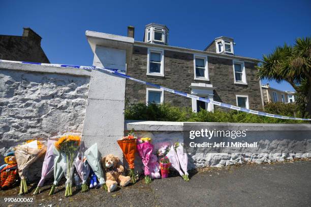 Tributes are left for six year old Alesha MacPhail at a house on Ardbeg Road on July 3, 2018 on the Isle of Bute, Scotland. Police investigations are...