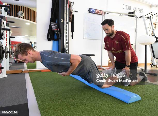 Rob Holding with Arsenal fitness coach Barry Solan during a medical screening session at London Colney on July 3, 2018 in St Albans, England.