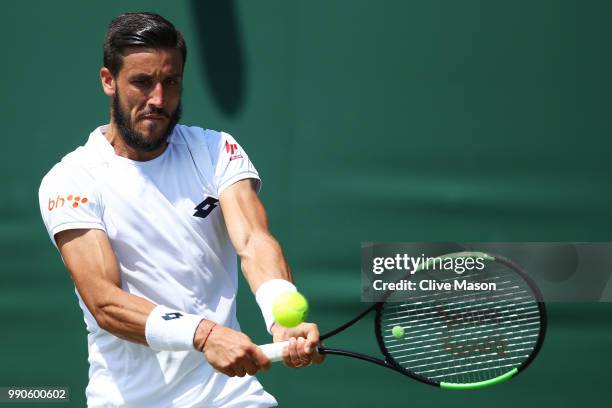Damir Dzumhur of Bosnia and Herzegovina returns against Maximilian Marterer of Germany during their Men's Singles first round match on day two of the...