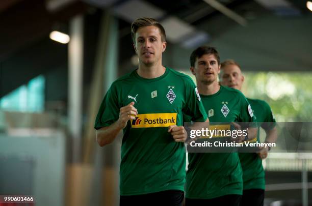 Patrick Herrmann, Jonas Hofmann and Oscar Wendt run during a lactate test of Borussia Moenchengladbach at Esprit Arena on July 03, 2018 in...