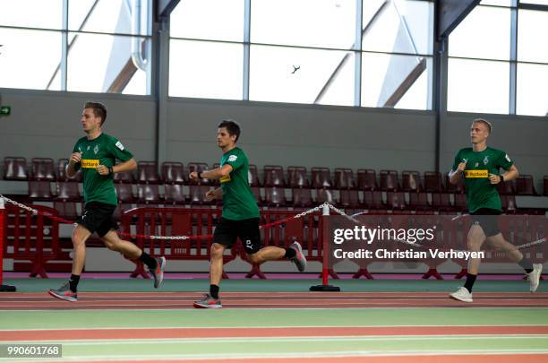 Patrick Herrmann, Jonas Hofmann and Oscar Wendt run during a lactate test of Borussia Moenchengladbach at Esprit Arena on July 03, 2018 in...