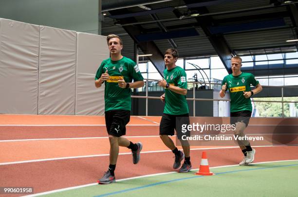 Patrick Herrmann, Jonas Hofmann and Oscar Wendt run during a lactate test of Borussia Moenchengladbach at Esprit Arena on July 03, 2018 in...
