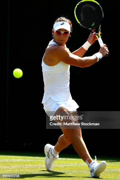 Samantha Stosur of Australia returns against Shuai Peng of China during their Ladies' Singles first round match on day two of the Wimbledon Lawn...