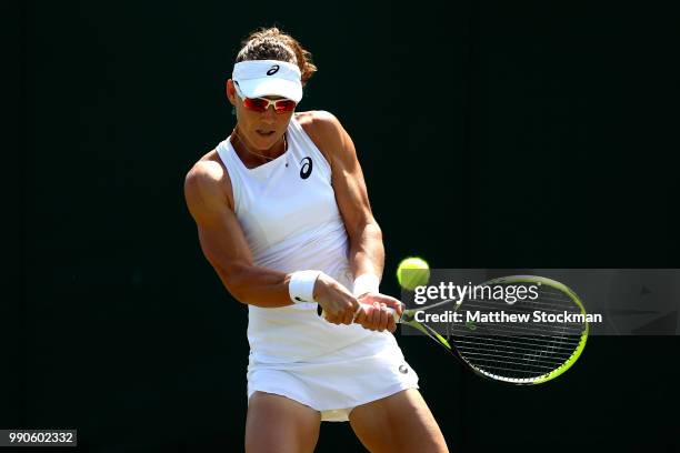 Samantha Stosur of Australia returns against Shuai Peng of China during their Ladies' Singles first round match on day two of the Wimbledon Lawn...