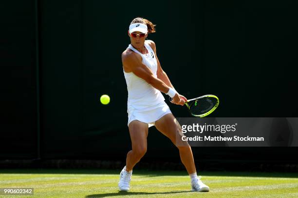 Samantha Stosur of Australia returns against Shuai Peng of China during their Ladies' Singles first round match on day two of the Wimbledon Lawn...