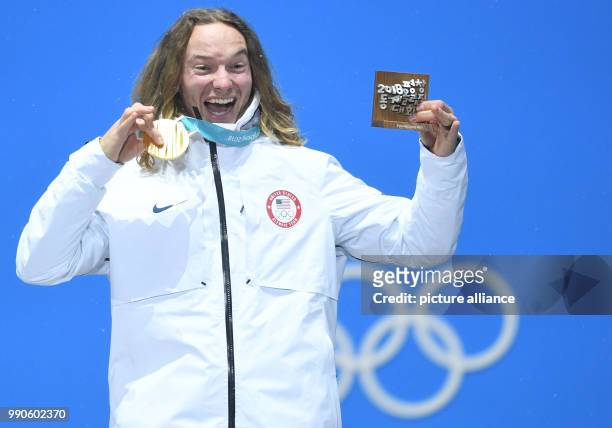 Dpatop - US gold medallist David Wise celebrate on the podium during the medal ceremony of the men's half-pipe freestyle skiing event on day 13 of...