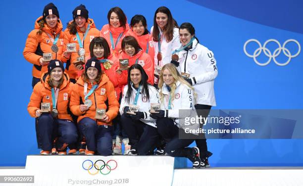 Dpatop - Dutch silver medallist team , Japanese gold medallist team, and the US bronze medallist team celebrate on the podium during the medal...