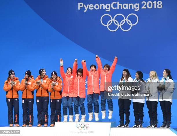 Dpatop - Dutch silver medallist team , Japanese gold medallist team, and the US bronze medallist team celebrate on the podium during the medal...