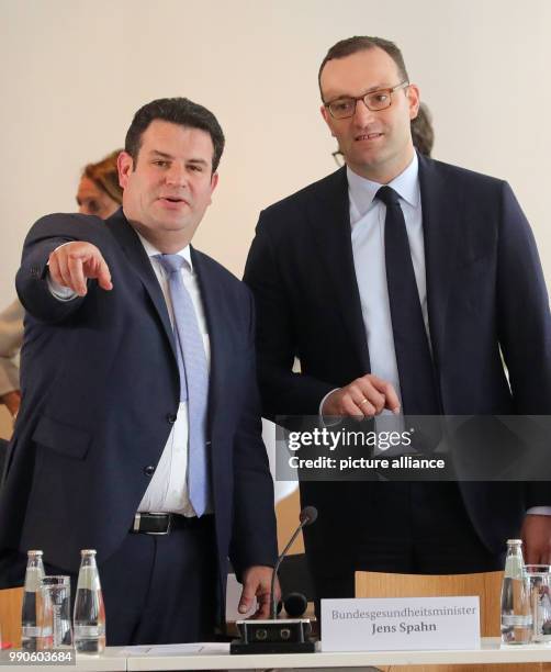 July 2018, Germany, Berlin: Minister for Health from the Christian Democratic Union , Jens Spahn , and Minister for Work, Hubertus Heil , at the...