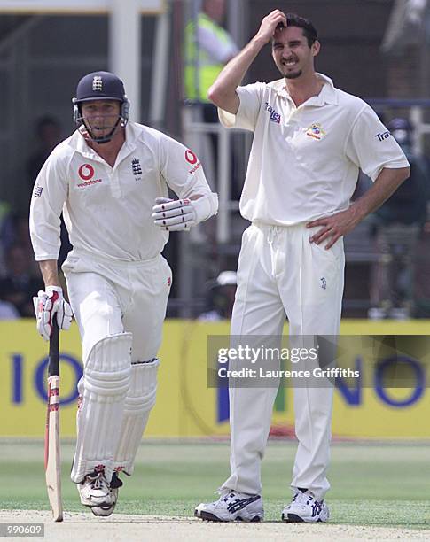 Mike Atherton of England runs past Jason Gillespie of Australia during the opening day of the NPower Ashes First Test match between England v...