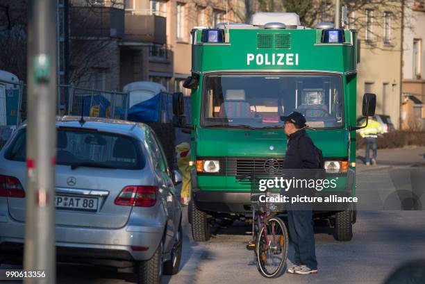 February 2018, Germany, Frankfurt am Main: A mobile police unit is parked in front of a construction site along the Koelner Street at the Gallus...