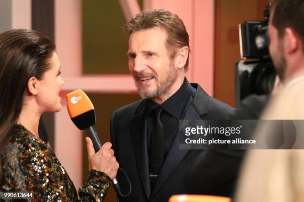 Northern Irish actor Liam Neeson speaks to media upon arrival at the 2017 Golden Camera Awards in Hamburg, Germany 22 February 2018. Photo: Georg...