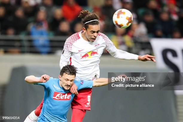 Leipzig's Yussuf Poulsen and Napoli's Mario Rui battle for the ball during UEFA Europa League round of 32 second leg soccer match between RB Leipzig...