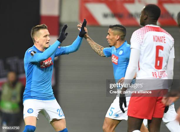 Napoli's Piotr Zielinski celebrates scoring his side's 1st goal during the UEFA Europa League round of 32 second leg soccer match between RB Leipzig...