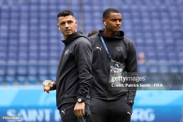 Blerim Dzemaili and Manuel Akanji of Switzerland look on durig pitch inspection prior to the 2018 FIFA World Cup Russia Round of 16 match between...