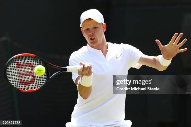 Kyle Edmund of Great Britain returns against Alex Bolt of Australia during their Men's Singles first round match on day two of the Wimbledon Lawn...