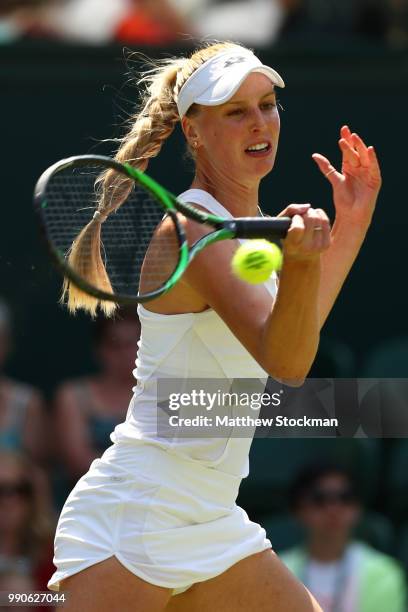 Naomi Broady of Great Britain returns against Garbine Muguruza of Spain during their Ladies' Singles first round match on day two of the Wimbledon...