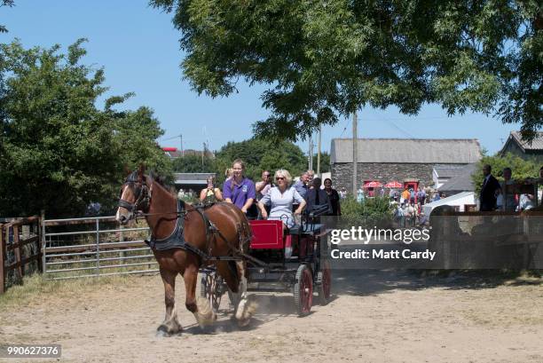 Camilla, the Duchess of Cornwall, is taken for a carriage ride as she visits Dyfed Shire Horse Farm in Eglwyswrw on July 3, 2018 in Pembrokeshire,...