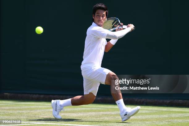 Yuichi Sugita of Japan returns against Bradley Klahn of the United States during their Men's Singles first round match on day two of the Wimbledon...