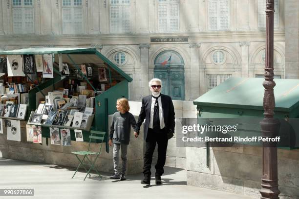 Hudson Kroenig and Chanel Stylist Karl Lagerfeld acknowledge the applause of the audience at the end of the Chanel Haute Couture Fall Winter...