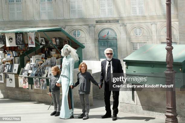 Model Adut Akech, Hudson Kroenig and Chanel Stylist Karl Lagerfeld acknowledge the applause of the audience at the end of the Chanel Haute Couture...