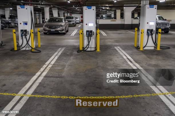 Electric vehicle charging stations stand in San Francisco, California, U.S., on Monday, July 2, 2018. General Motors Co. Has installed 18 fast...
