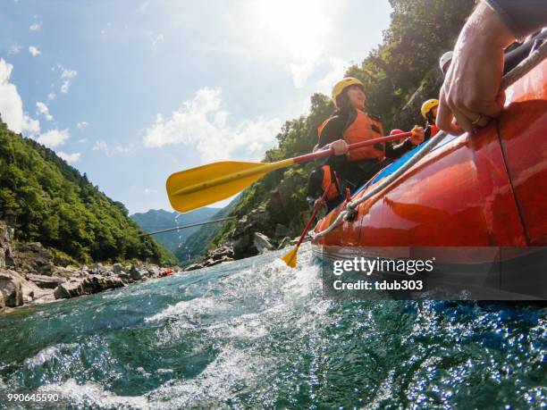 low angle view of a white water river rafting excursion - rafting stock pictures, royalty-free photos & images