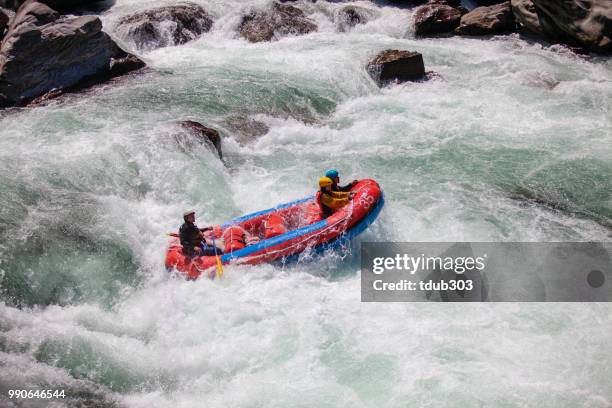 married couple on a guided white water river rafting tour - iya valley stock pictures, royalty-free photos & images