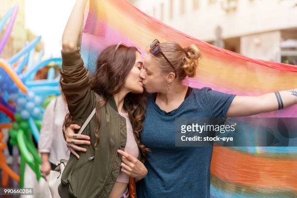 beautiful females kissing walking on the street - images of lesbians kissing stock pictures, royalty-free photos & images