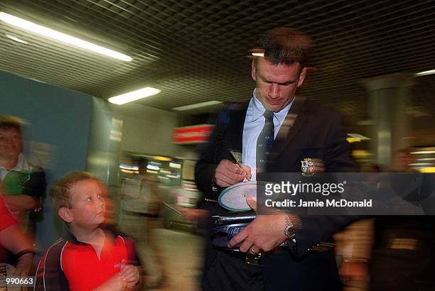Tour Captain Martin Johnson signs an autograph for a young fan at Heathrow Airport prior to his departure on the British Lions tour of Australia....