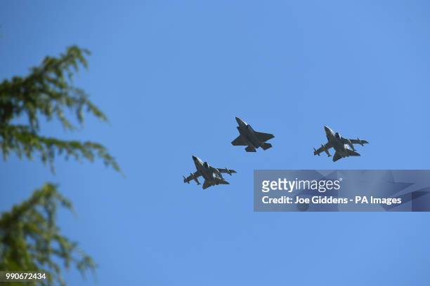 An F-35 Lightning stealth jet is flanked by a pair of Tornado GR4's from the Royal Air Force as they fly over RAF Cranwell in Lincolnshire as a...