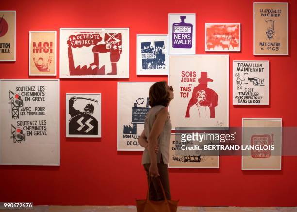 People visit the exhibition "1968, quelle histoire !" as part of the photography festival "Les Rencontres de la photographie - Arles 2018" in Arles,...