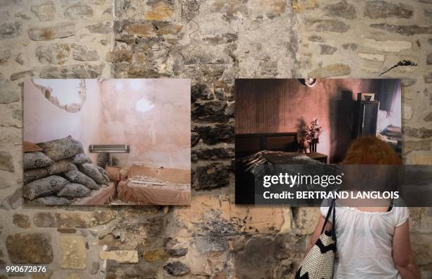People visit the exhibition "Une colonne de fumee" focusing on Turkish contemporary photography as part of the photography festival "Les Rencontres...