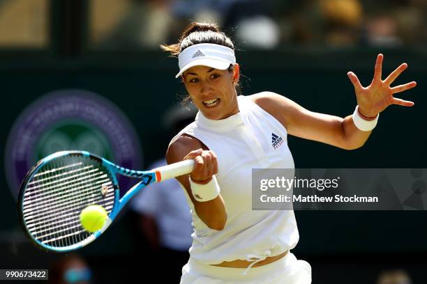 Garbine Muguruza of Spain returns against Naomi Broady of Great Britain during their Ladies' Singles first round match on day two of the Wimbledon...