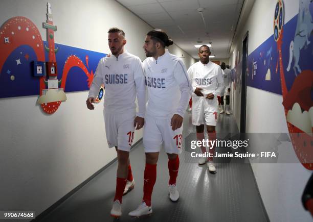 Josip Drmic, Ricardo Rodriguez and Gelson Fernandes of Switzerland walk in the tunnel prior to the 2018 FIFA World Cup Russia Round of 16 match...