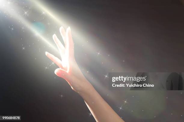 woman's hands reaching a glowing light - 神 ストックフォトと画像