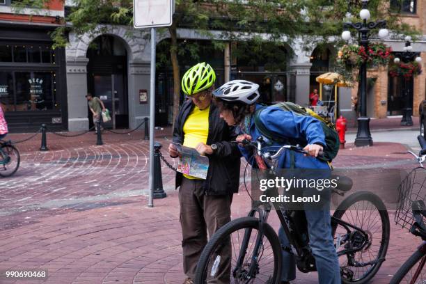 looking at map at gastown on canada day,vancouver,canada - sunny leon stock pictures, royalty-free photos & images